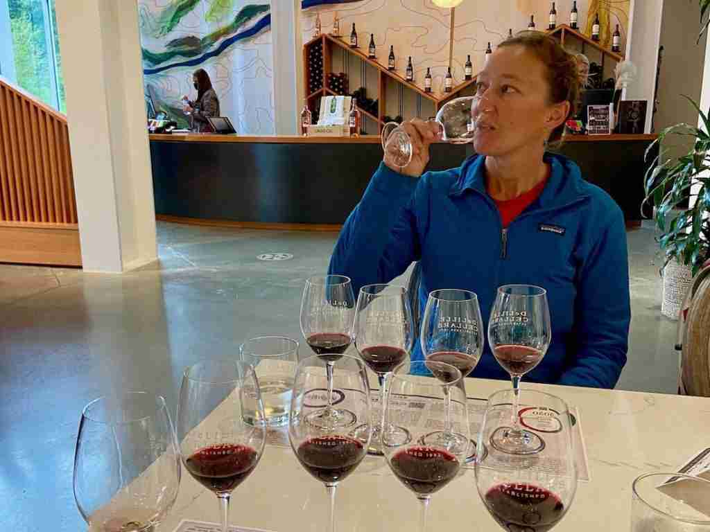 Woman sipping wine at a wine tasting in Woodinville, Washington